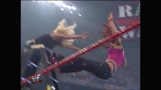 Trish Stratus puts Lita through a table from the top of a ladder