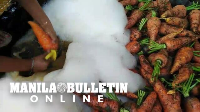 Vendors clean newly-delivered carrots at Bankerohan Market in Davao City