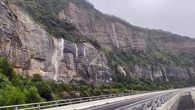 ILLAWARRA MERCURY: The rain pours down the escarpment near Sea Cliff Bridge, April 7, 2022
