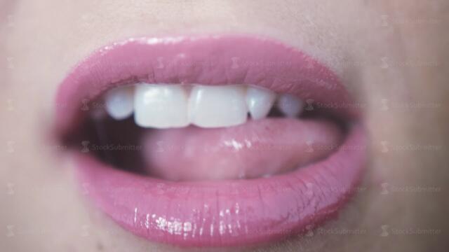 Close up beautiful pink lips lick of young girl. 3840x2160