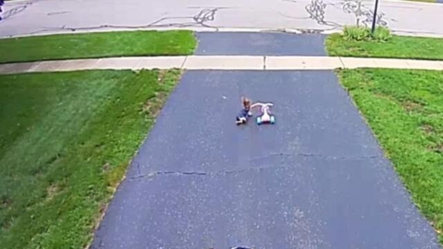 Baby Dramatically Falls While Walking Down Driveway With Tricycle