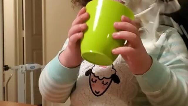 Little Girl Accidentally Spills Drink While Playing Cheers With Mom