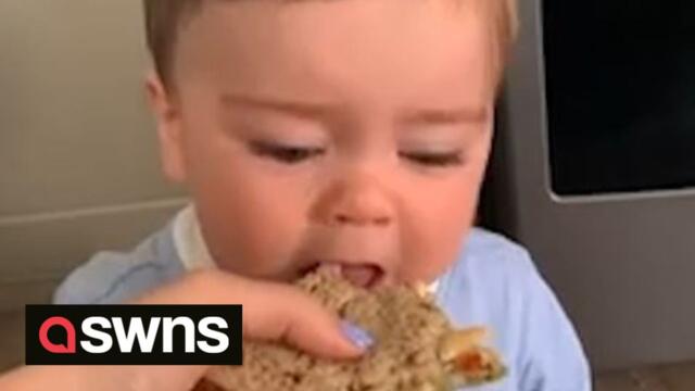 Adorable baby gets frustrated as he is unable to take a bite from his mum’s sandwich