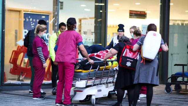 Nurses break a picket line to help an injured man