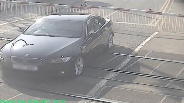 Heart-stopping moment BMW driver gets stuck on a level crossing as train approaches
