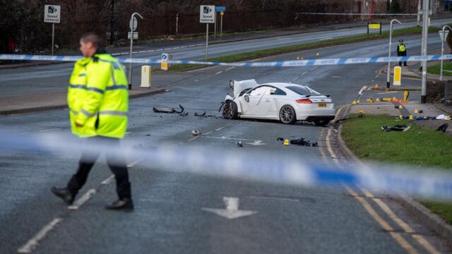 Police have shut key routes in North Leeds after a car hit the Vertu Jaguar car garage.