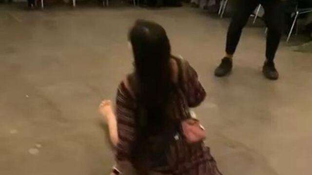 Woman Performs Leg Split at Wedding Dance While Holding Her Baby