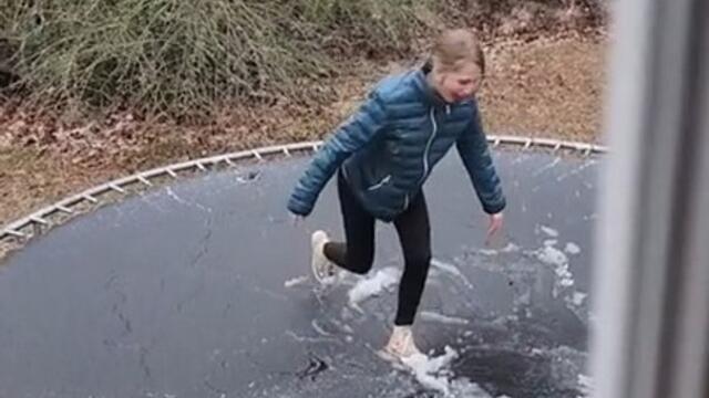 Girl Trips and Falls While She Repeatedly Tries to Jump on Frozen Trampoline