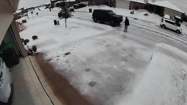 Couple Struggles to Walk Through Driveway Due to Heavy Snow in Dallas, Texas