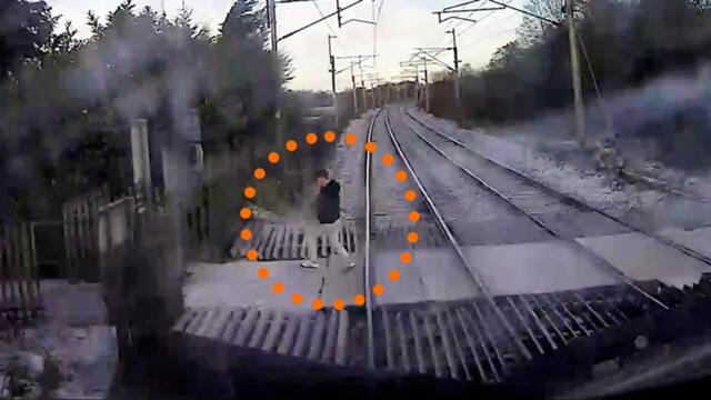 High-speed train narrowly misses pedestrian crossing tracks after ignoring warnings