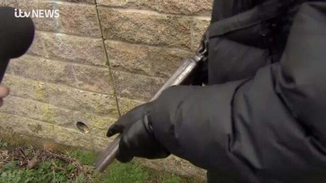 Masked man pulls out loaded gun during interview with ITV News