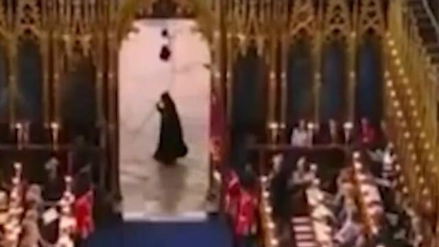 Moment mysterious cloaked figure runs past Westminster Abbey during coronation