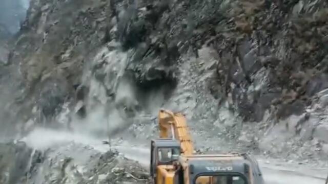 Moment boulders and debris rain down on road as cliff face collapses
