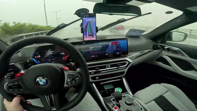 drive new BMW M4 passing through heavy rain