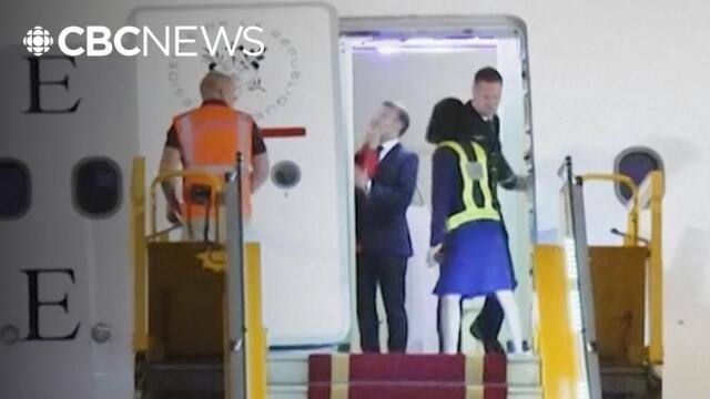 French President Emmanuel Macron pushed in the face as he prepares to deplane