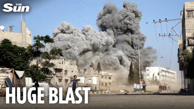 Moment huge explosion hits school in Gaza sending people running for cover