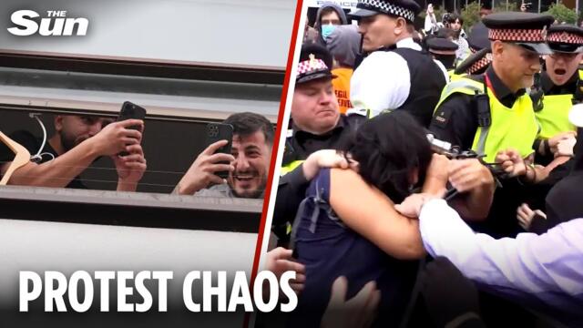 Migrant hotel residents ‘blow kisses’ from window as they film violent clashes on street
