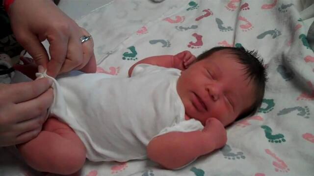 Isabella gets dressed for her trip home from the hospital