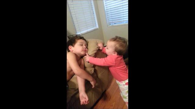 Baby sister tries to wake her big brother