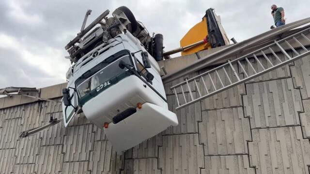 Truck Hangs Off Overpass After Losing Control On Road
