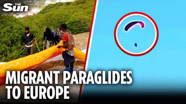 Shocking moment migrant PARAGLIDES over heavily-fortified border fence as he sneaks into Spain